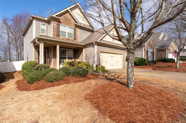 view of front of house with concrete driveway, fence, and an attached garage