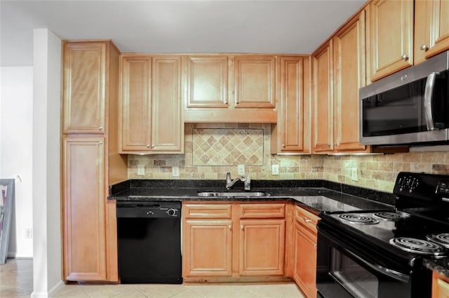 kitchen featuring dark stone countertops, black appliances, decorative backsplash, sink, and light tile patterned flooring