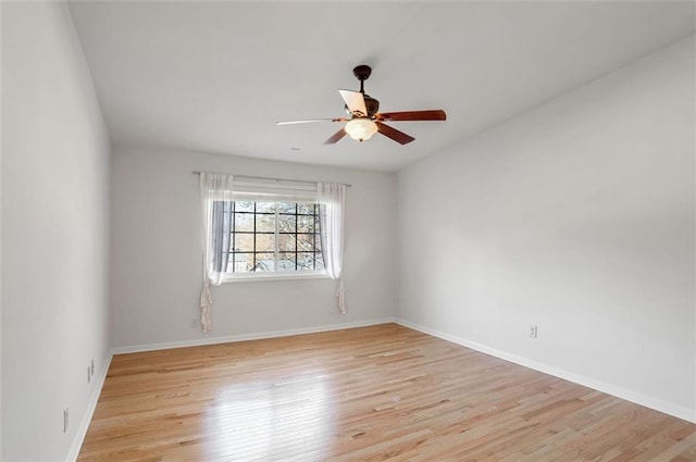 spare room with light hardwood / wood-style floors and ceiling fan