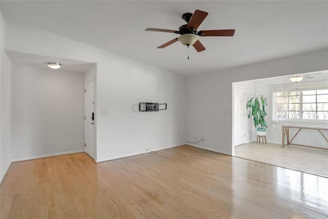 spare room featuring light wood-type flooring and ceiling fan