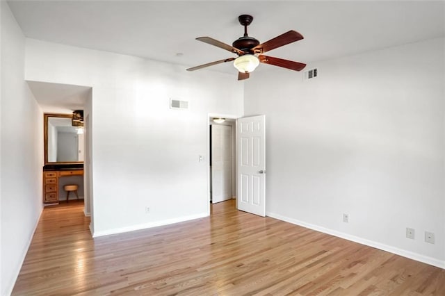 spare room featuring ceiling fan and light wood-type flooring