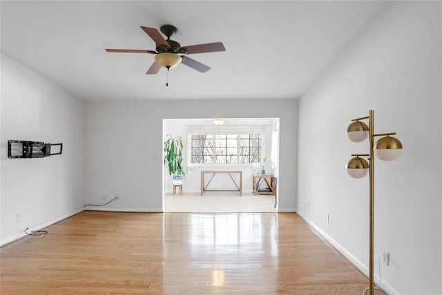 empty room featuring ceiling fan and light hardwood / wood-style floors