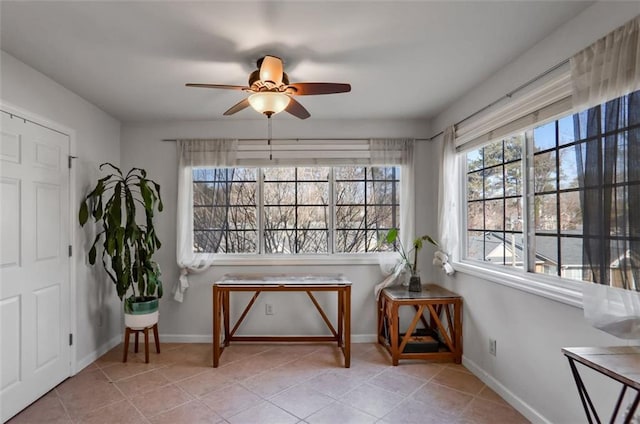 living area with ceiling fan and light tile patterned floors