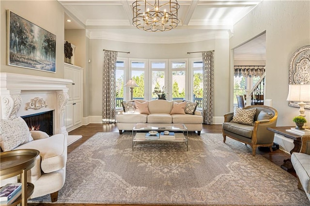 living room with plenty of natural light, a high end fireplace, and coffered ceiling