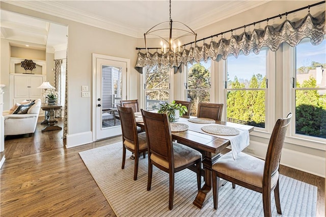 dining area featuring a notable chandelier, crown molding, and dark wood-type flooring