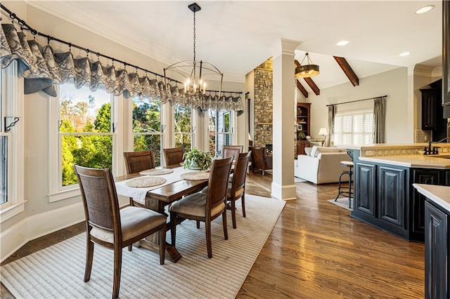 dining area featuring vaulted ceiling with beams, dark wood-type flooring, a chandelier, and decorative columns