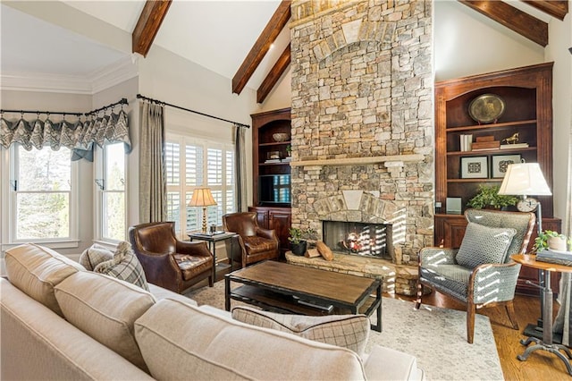 living room featuring hardwood / wood-style floors, lofted ceiling with beams, and a stone fireplace