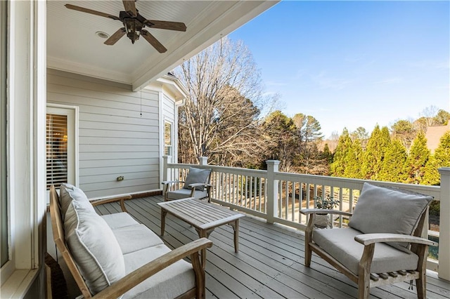 wooden deck with an outdoor living space and ceiling fan