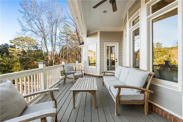 deck featuring outdoor lounge area and ceiling fan