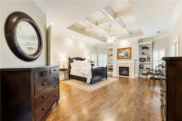 bedroom with multiple windows, light hardwood / wood-style flooring, beamed ceiling, and coffered ceiling