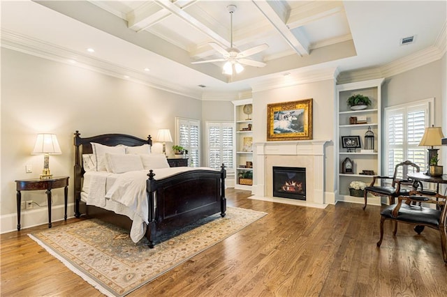 bedroom featuring beamed ceiling, ceiling fan, crown molding, and coffered ceiling