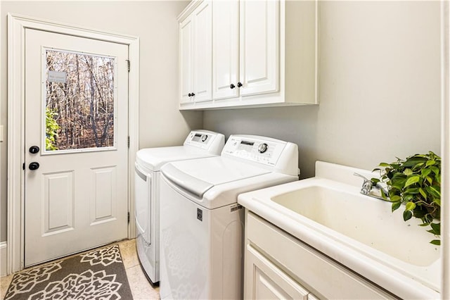 washroom featuring cabinets, light tile patterned floors, washer and clothes dryer, and sink