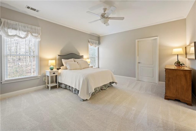 carpeted bedroom with ceiling fan and crown molding