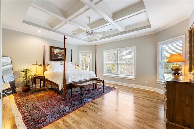 bedroom featuring coffered ceiling, light hardwood / wood-style flooring, ceiling fan, ornamental molding, and beam ceiling