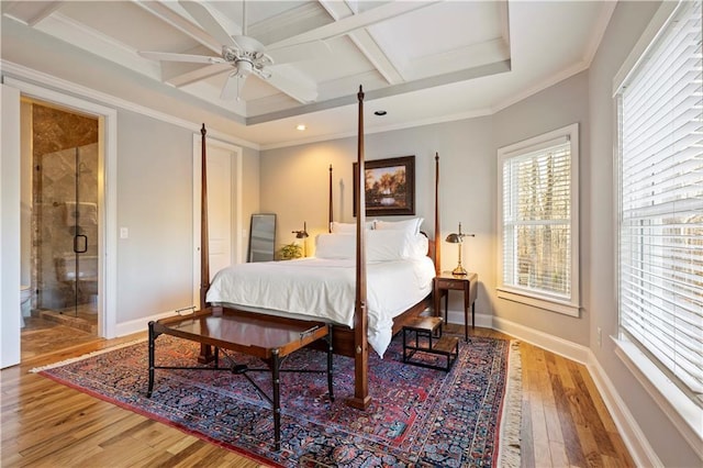 bedroom featuring ensuite bath, coffered ceiling, ceiling fan, crown molding, and beam ceiling