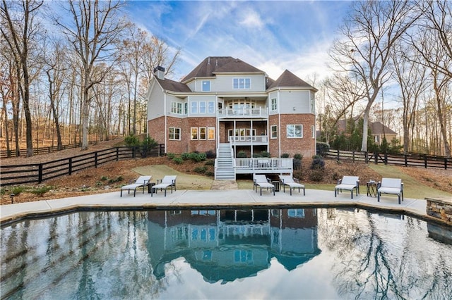 back of property with a patio area and a balcony