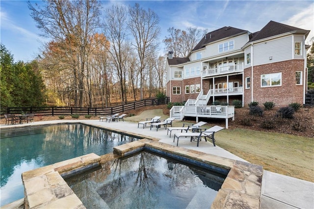 view of pool featuring a yard, a deck, an in ground hot tub, and a patio