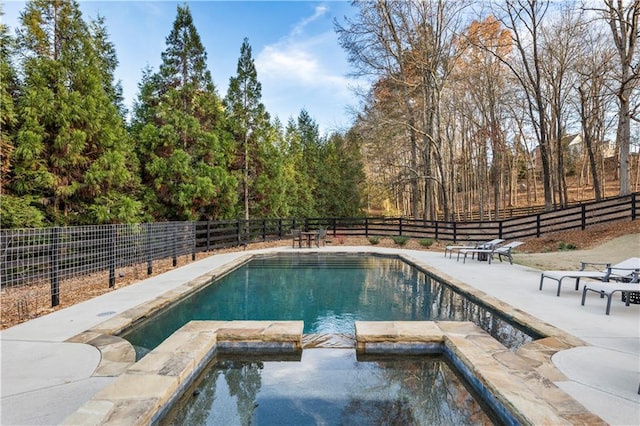 view of swimming pool featuring a patio area and an in ground hot tub