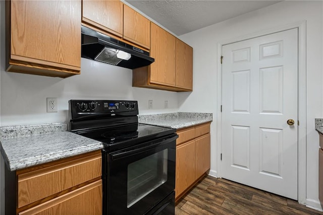 3303 Par Three Way, Lithonia, GA 30038 - kitchen featuring black range with electric cooktop, under cabinet range hood, dark wood finished floors, and light countertops