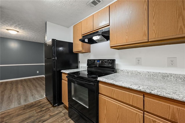 3303 Par Three Way, Lithonia, GA 30038 - kitchen featuring under cabinet range hood, black appliances, dark wood-style floors, a textured ceiling, and light stone counters