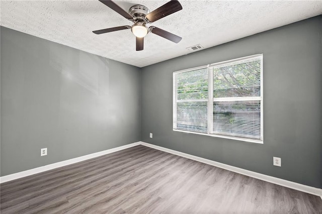 3303 Par Three Way, Lithonia, GA 30038 - unfurnished room featuring a textured ceiling, wood finished floors, and a ceiling fan