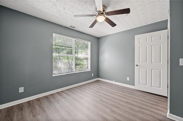 3303 Par Three Way, Lithonia, GA 30038 - spare room featuring wood finished floors, a textured ceiling, and ceiling fan