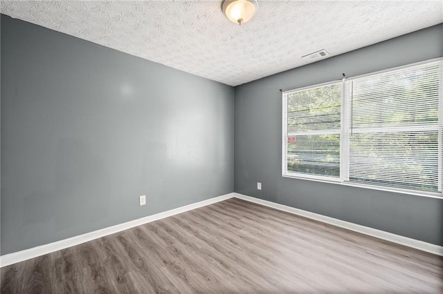 3303 Par Three Way, Lithonia, GA 30038 - empty room with wood finished floors and a textured ceiling