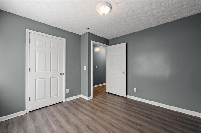 3303 Par Three Way, Lithonia, GA 30038 - unfurnished bedroom featuring wood finished floors and a textured ceiling