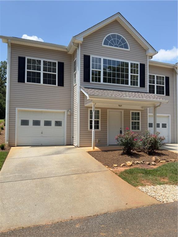 118 Pointe Cir, Dahlonega, GA 30533 - traditional home with an attached garage, concrete driveway, and covered porch
