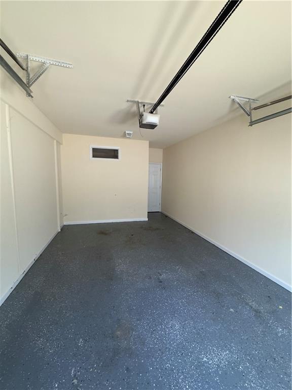 118 Pointe Cir, Dahlonega, GA 30533 - garage featuring a garage door opener and baseboards