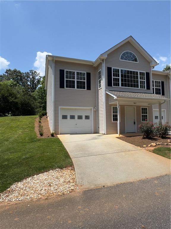 118 Pointe Cir, Dahlonega, GA 30533 - traditional-style home with an attached garage, concrete driveway, and a front lawn