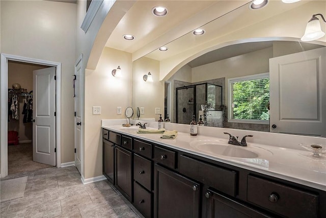 bathroom with walk in shower and vanity