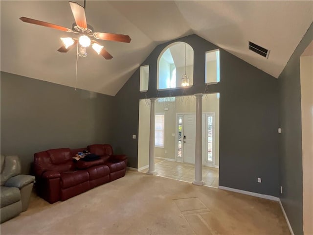 carpeted living room featuring lofted ceiling, ceiling fan, and ornate columns