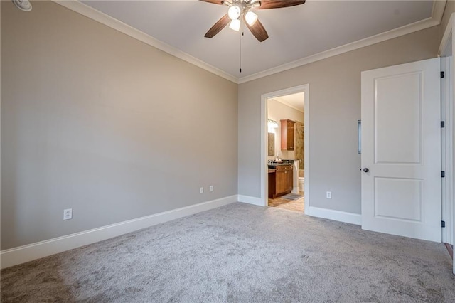 unfurnished bedroom with crown molding, light colored carpet, ceiling fan, and ensuite bath