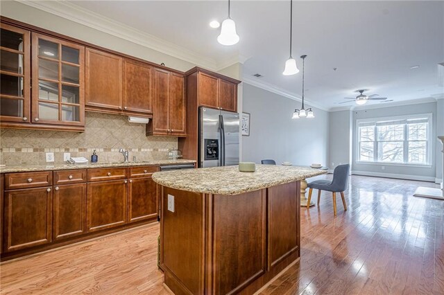 kitchen featuring light stone counters, sink, and backsplash