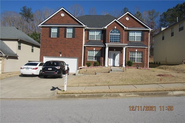 view of front of property with a garage, concrete driveway, and brick siding