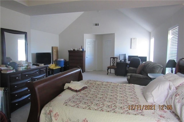 carpeted bedroom featuring high vaulted ceiling and visible vents