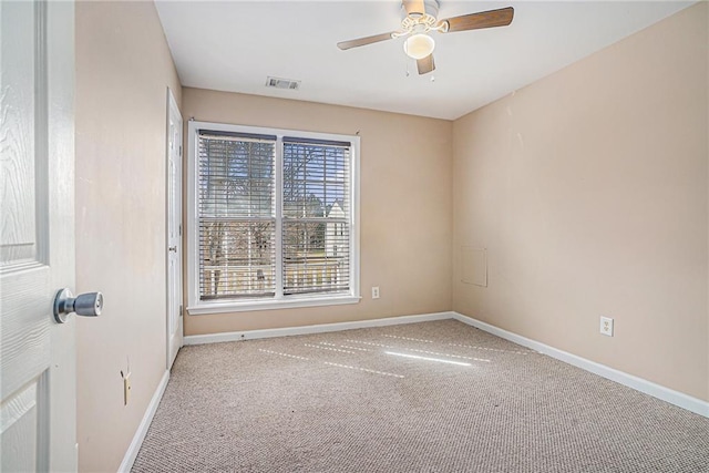 carpeted empty room featuring ceiling fan