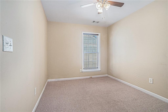 unfurnished room with ceiling fan and carpet