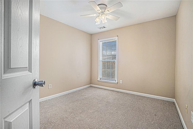 unfurnished room with light colored carpet and ceiling fan