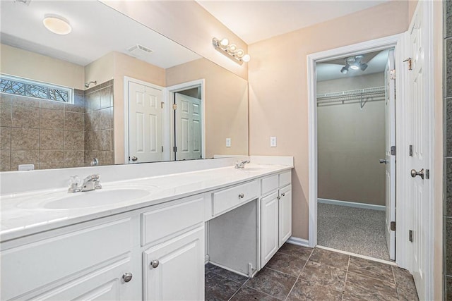 bathroom with a shower and vanity