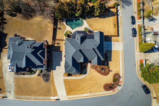 view of home's community with a lawn and a pergola