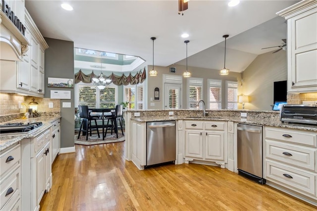 kitchen with a wealth of natural light, ceiling fan, stainless steel appliances, and a sink