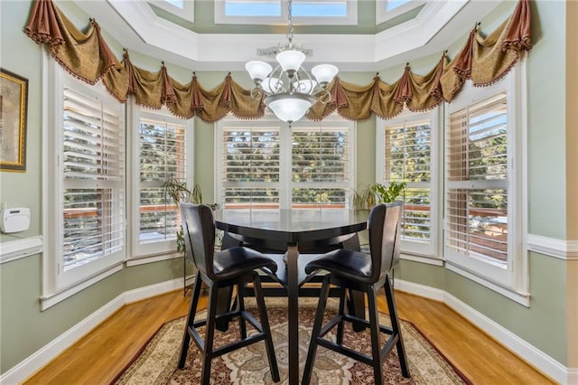 dining room with a chandelier, a wealth of natural light, and baseboards