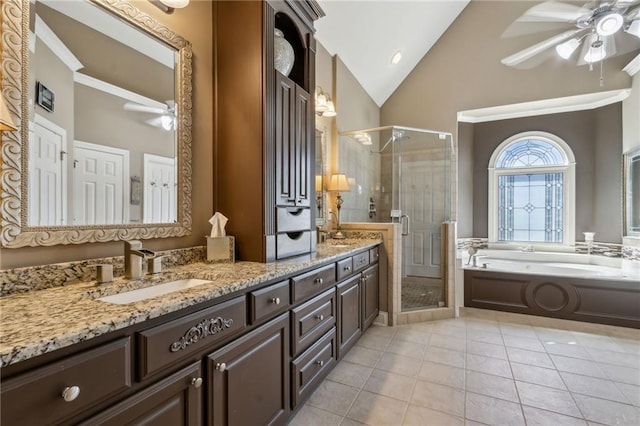 bathroom featuring lofted ceiling, a garden tub, a sink, a ceiling fan, and a stall shower