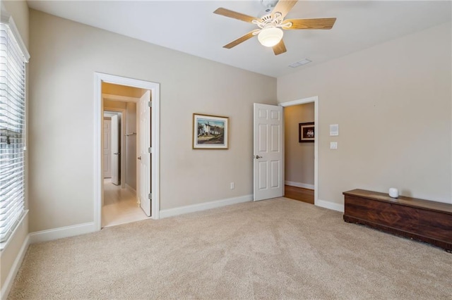 unfurnished bedroom featuring carpet floors, ceiling fan, and baseboards