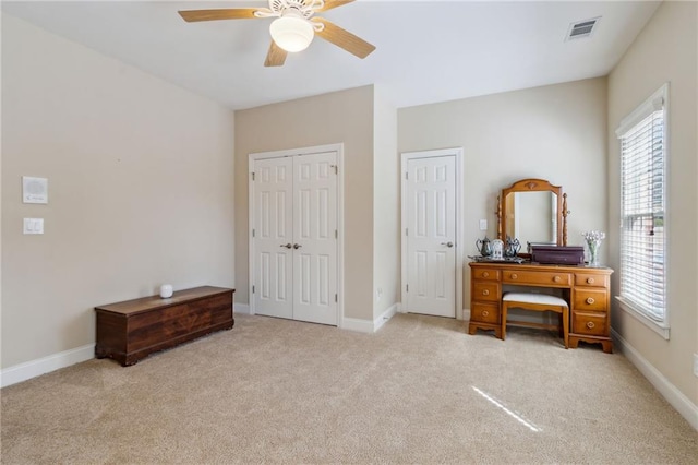 bedroom with light colored carpet, visible vents, and baseboards