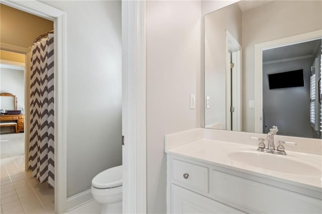 bathroom with toilet, tile patterned floors, and vanity