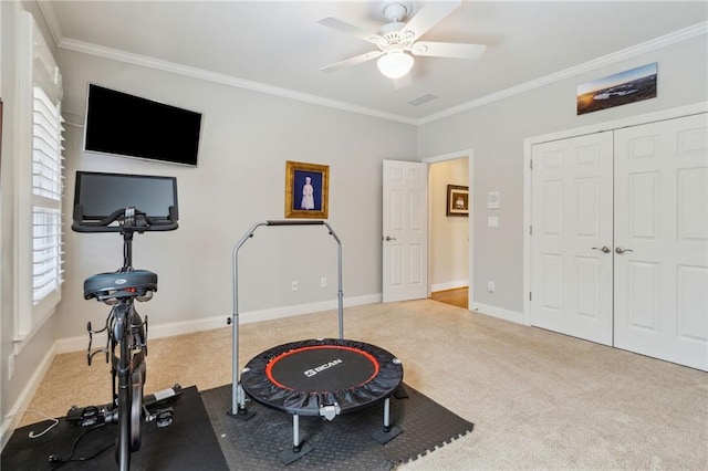 workout area with ceiling fan, ornamental molding, carpet, and baseboards