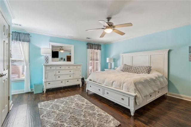 bedroom with baseboards, visible vents, dark wood finished floors, and crown molding